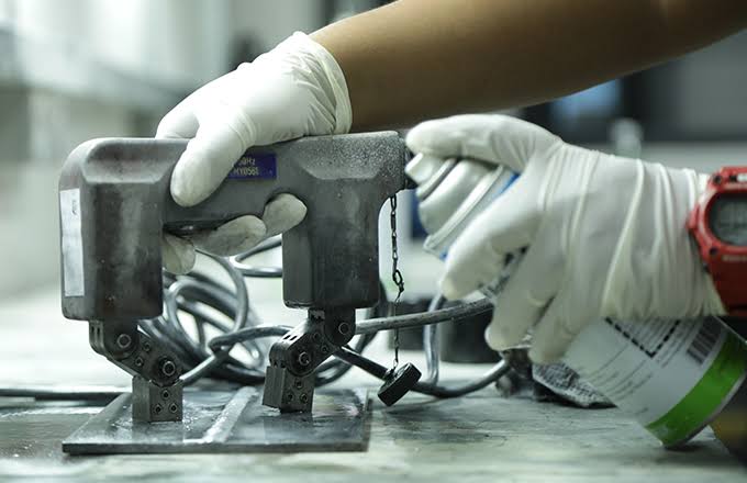 Magnetic Particle Inspection being performed on ferromagnetic component